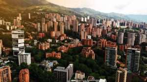 Aerial View of the Poblado neighborhood in Medellin Colombia during sunset with the mountains on the backgroung