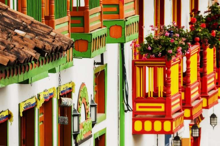 Colorful facades of a town's houses in Antioquia with colorful balconies and flowers in Antioquia Colombia