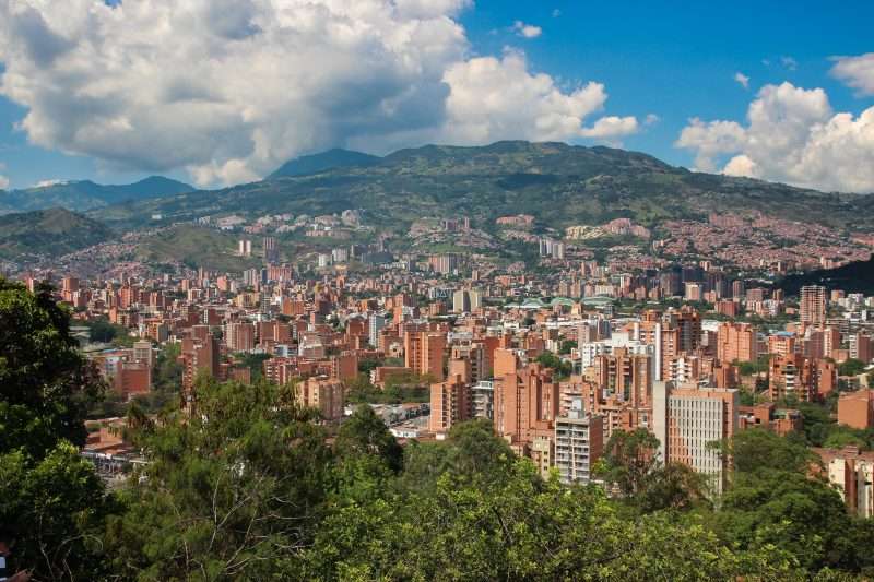 View of the buildings of Medellin, Colombia during a sunny day with the mountains in the background
