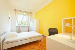 Bedroom for rent in renovated apartment with yellow wall