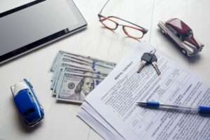 Rent contract with keys and us money on office table