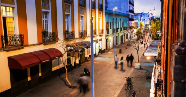 Mexico City is the capital of Mexico. Nightlife in Mexico City. Streets of the center with blurred people, bars, restaurants and cafes.